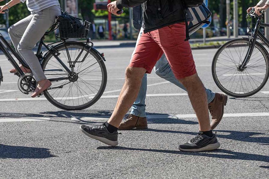 People biking and walking on crosswalk